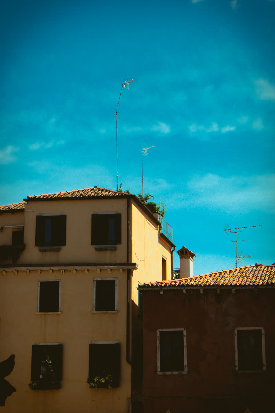 Ochre and terracotta buildings against a deep teal sky