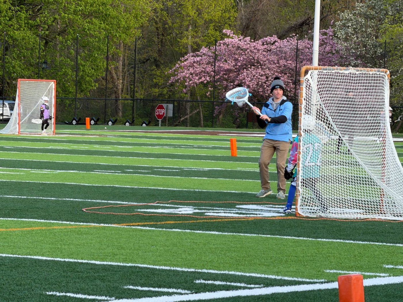 Jack Crombie coaching a young goalie by the net