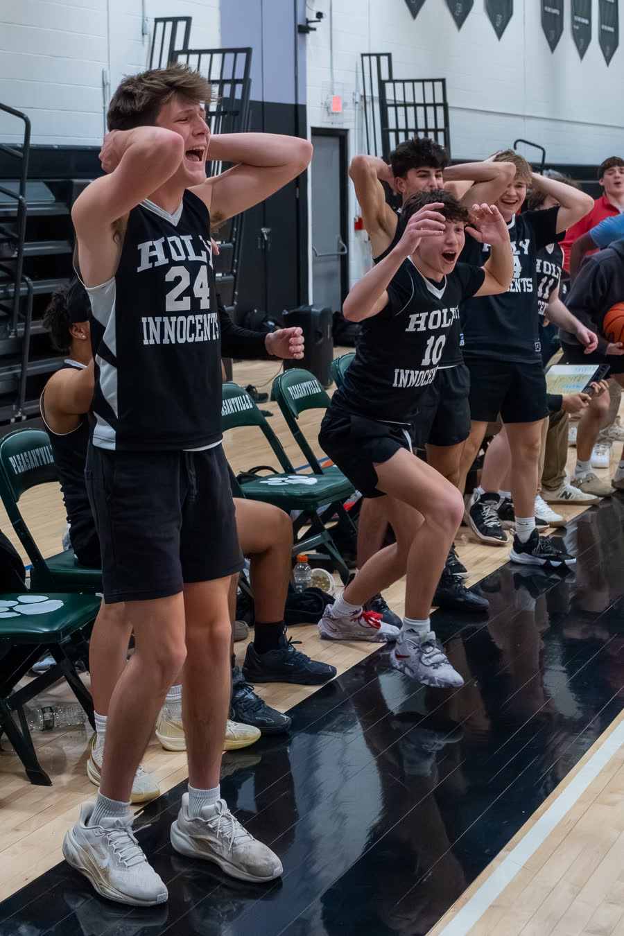 Bench players on their feet reacting to a play