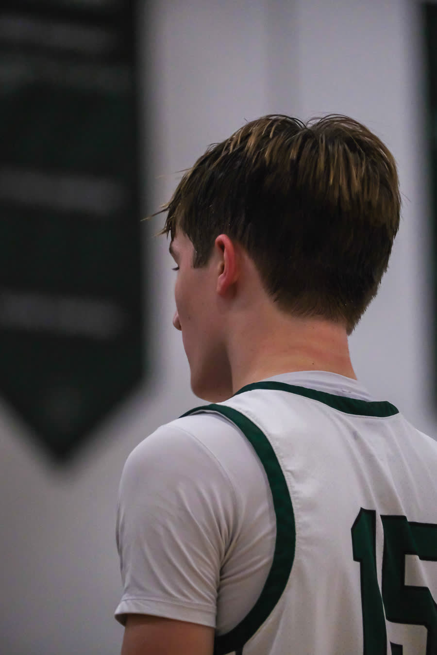 A player in a number 15 jersey, framed tight from behind