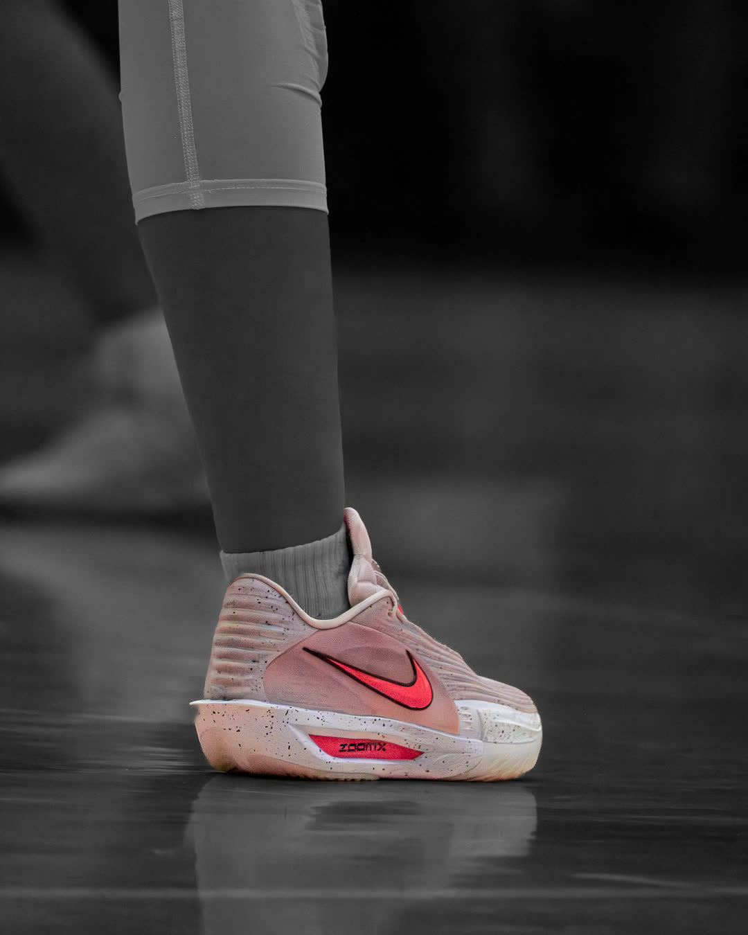 Detail of a basketball shoe planted on the court