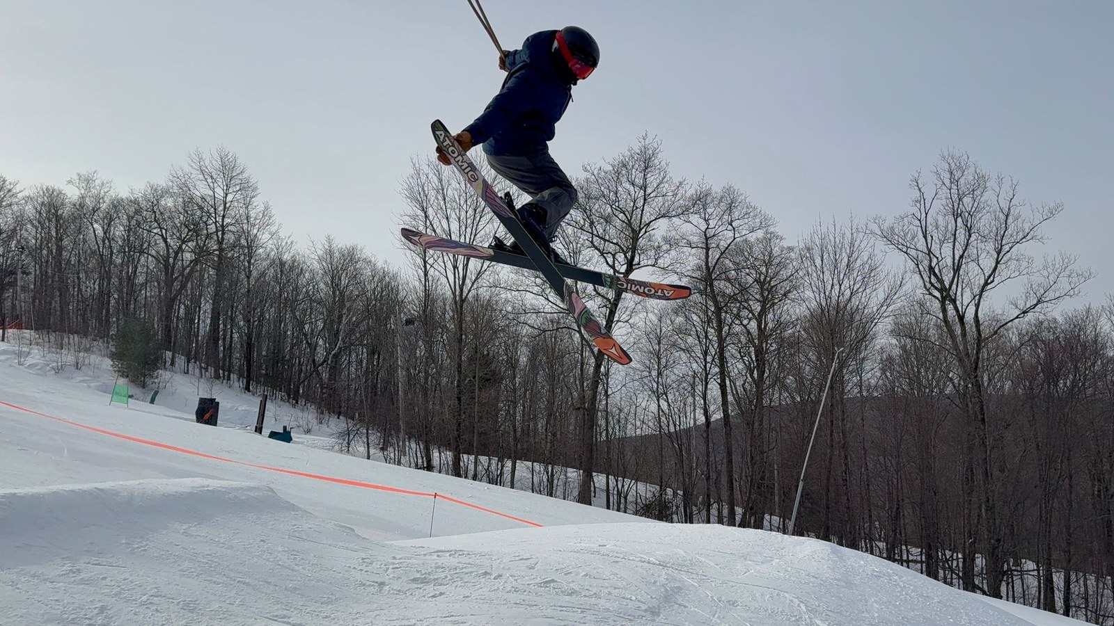 Jack Crombie mid-air on a ski jump